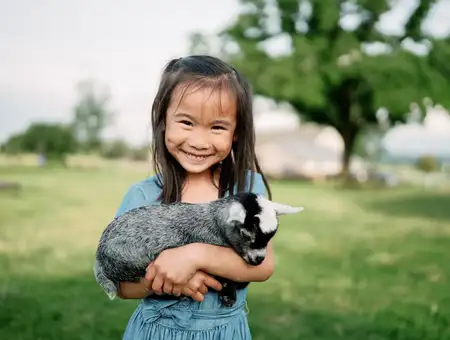 Child holding a baby goat at Verdant View Farm Tours, Lancaster PA