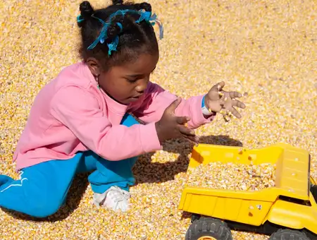 Child playing in a corn kernel pit at Corn Cob Acres, Lancaster PA