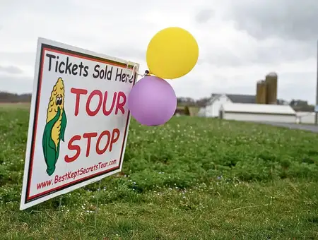 Tour stop sign with balloons in farm field for Best Kept Secrets Tour in Lancaster PA