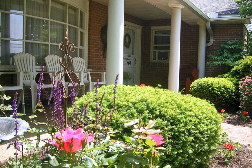 Front porch garden with roses and salvia at Leaman's Country Lodging, Lancaster PA