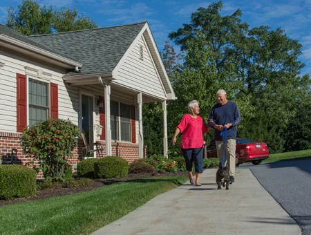United Zion Retirement Community couple walking dog outside residential cottage in Lancaster PA