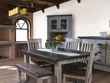 Rustic farmhouse dining table with a bench and mismatched chairs, staged in front of a distressed hutch in a barn-style room at Creative Rustic Furniture