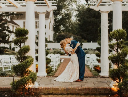 White Chimneys Estate outdoor wedding ceremony with couple kissing under pergola in Lancaster PA