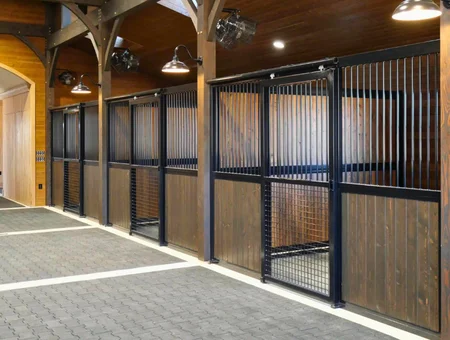 Custom wood and black steel horse stall panels inside equestrian barn by J&E Grill Manufacturing in Lancaster PA