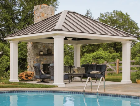 Custom backyard pavilion with stone fireplace and inground pool by Lancaster County Backyard in Lancaster PA