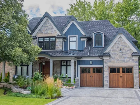 Slate gray shingle roof on stone and blue siding home with stone facade by Indian Run Roofing in Lancaster PA
