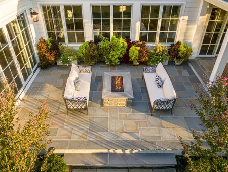 Custom flagstone patio with fire pit seating area and landscaping by Kauffman Exteriors Improvements in Lancaster PA