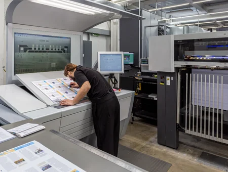 Professional printing technician operating commercial printing equipment at Little Mountain Printing in Lancaster PA