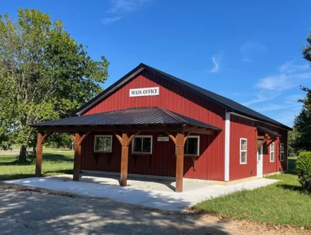 Tucquan Hollow Builders custom red barn with covered porch and metal roof in Lancaster PA