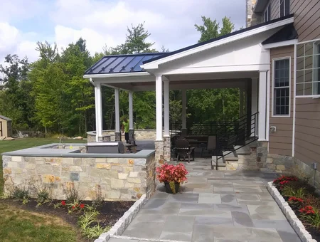 Custom covered porch with stone retaining wall and slate patio walkway by King View Carpentry in Lancaster PA