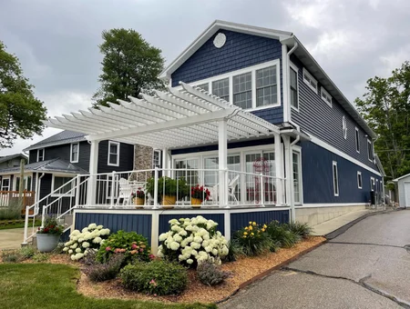 White attached pergola over deck on navy blue home by Garbrella Pergolas in Lancaster PA