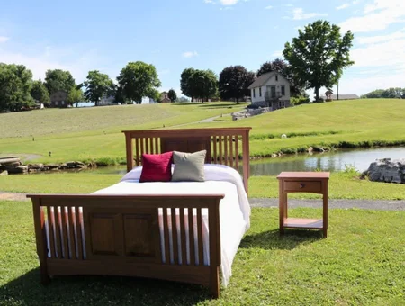 Mission style solid wood bed and nightstand displayed outdoors at Georges Furniture Lancaster PA