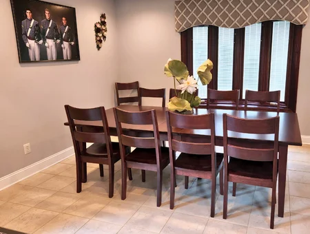 Dark wood dining table with ladder back chairs in home setting at Georges Furniture Lancaster PA