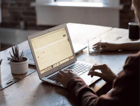 Designer working on laptop website project for Gumption Design Co in Lancaster PA