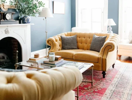 Yellow tufted sofa and armchair beside a fireplace in a living room at Freedom Home with Secret Room