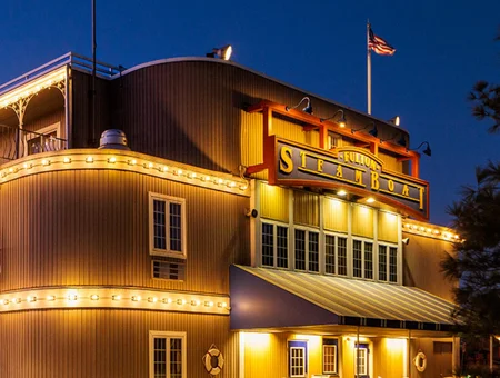 Fulton Steamboat Inn exterior lit up at night with a Mississippi riverboat-style facade