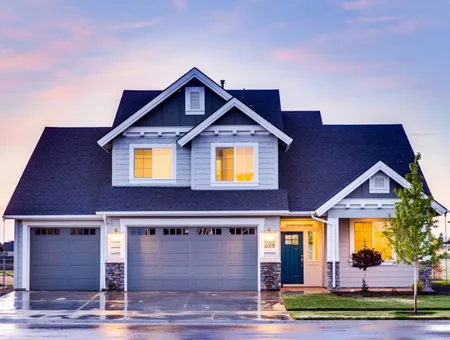 Navy blue roof and gray siding installation on two-story home at dusk by Hillcrest Roofing and Siding in Lancaster PA