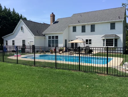 White vinyl siding and gray shingle roof on home with backyard pool by Hillcrest Roofing and Siding in Lancaster PA
