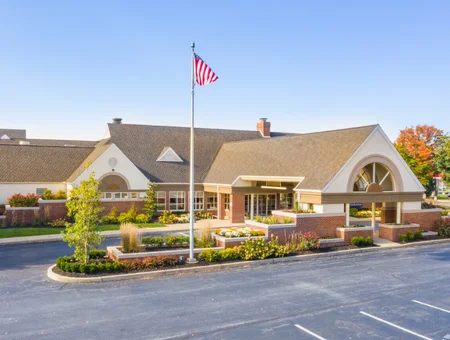 Entrance of Hilton Garden Inn Lancaster with landscaped flower beds and a flagpole
