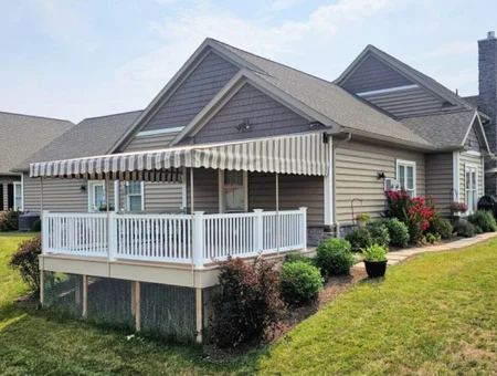 Retractable striped deck awning on white railing raised deck by Kreider's Canvas in Lancaster PA