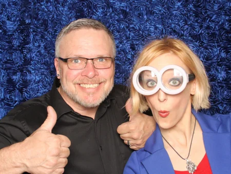 Guests posing with oversized novelty glasses prop at event photo booth by Hey Photobooth in Lancaster PA