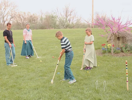 Family playing croquet outdoors with Amish wooden toys at AmishToyBox Lancaster PA
