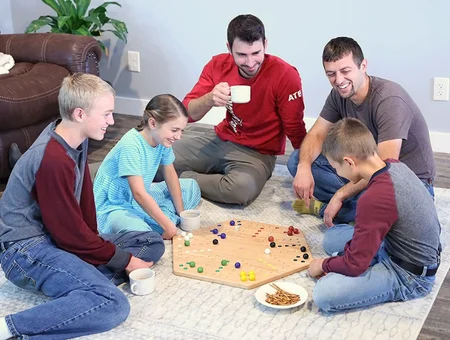 Group playing Amish handcrafted wooden marble game together at AmishToyBox Lancaster PA