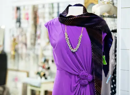 Purple dress with necklace on a mannequin display at Freedom Thrift donated clothing store in Lancaster PA