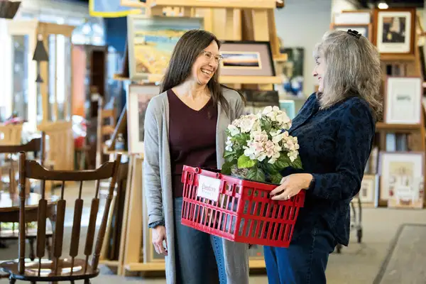 Two women shopping for home decor and flowers at Freedom Thrift store in New Holland Lancaster PA