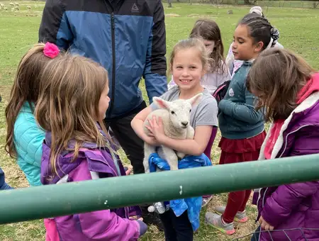 Kids holding a baby lamb at Oregon Dairy Farmstead fall family fun activities in Lancaster PA