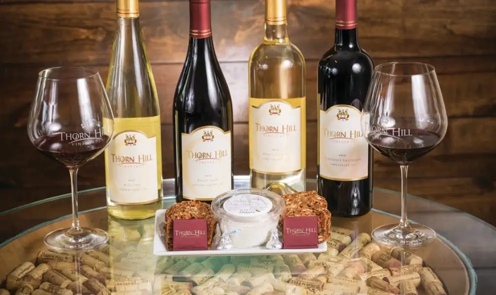 Thorn Hill Vineyards wine bottles and glasses with cheese and crackers, winery tasting experience in Lancaster PA