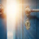 Mysterious glowing door with ornate brass handles for escape room experience in Lancaster PA