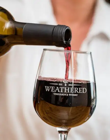 Red wine being poured into a Weathered Vineyards and Winery glass in Lancaster County PA