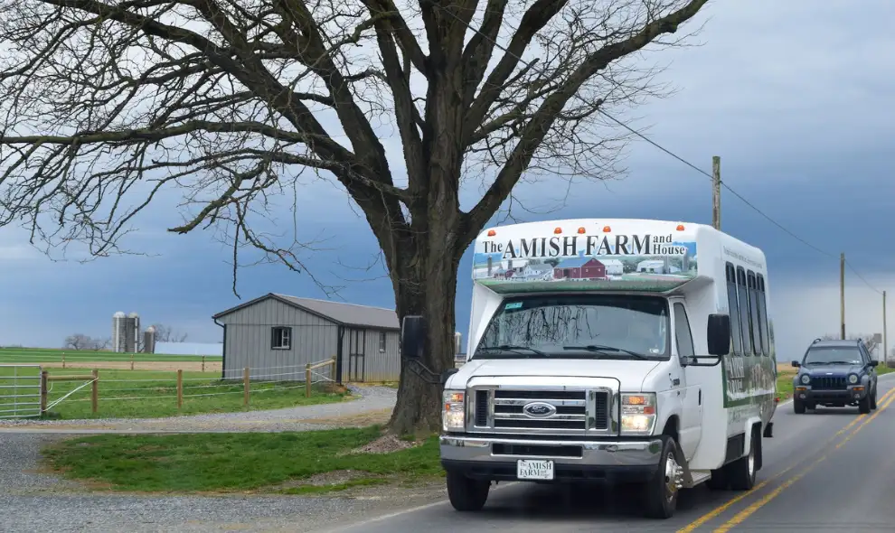 The Amish Farm and House tour bus driving through Lancaster PA countryside, Amish country attraction and guided tour