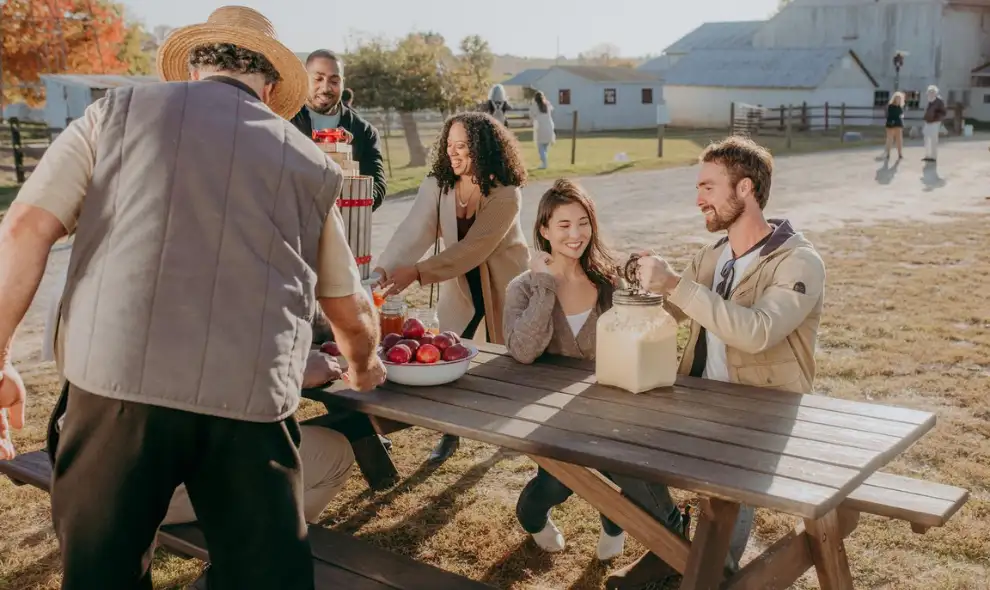 Friends enjoying fresh apples and cider at an Amish farm in Lancaster PA, things to do near Old Windmill Farm