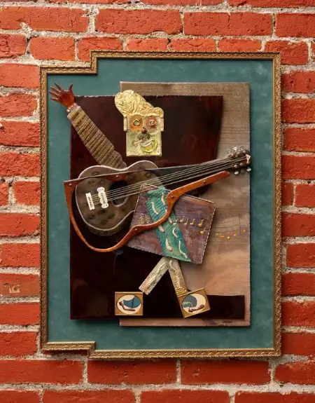 Mixed media guitar wall art on exposed brick at Lancaster Arts Hotel gallery in Lancaster City PA