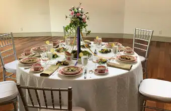 Elegant banquet table setting at Pheasant Run Farm in Lancaster PA with floral centerpiece and chiavari chairs