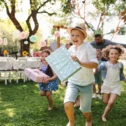 Kids running with birthday gifts at an outdoor birthday party at Cherry Crest Adventure Farm in Lancaster PA