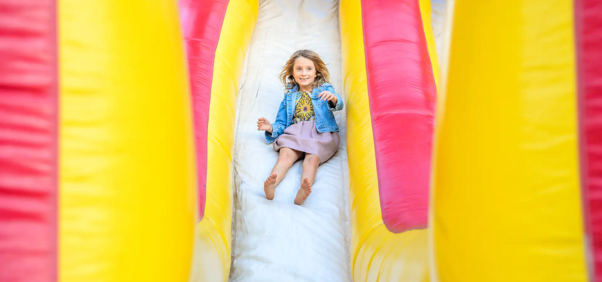 Girl sliding down inflatable bounce house rental in Lancaster PA