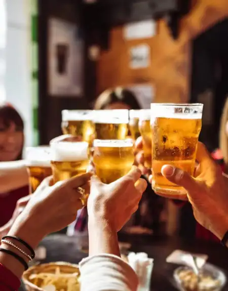 Friends toasting craft beer pints at a Lancaster PA brewery