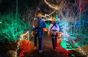 Couple walking through Christmas light display at night in Lancaster PA