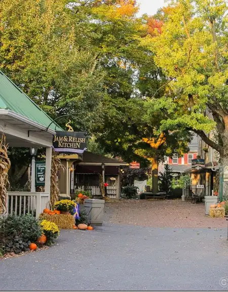 Fall foliage and pumpkins along the shop-lined walkway at Kitchen Kettle Village in Intercourse Lancaster County PA