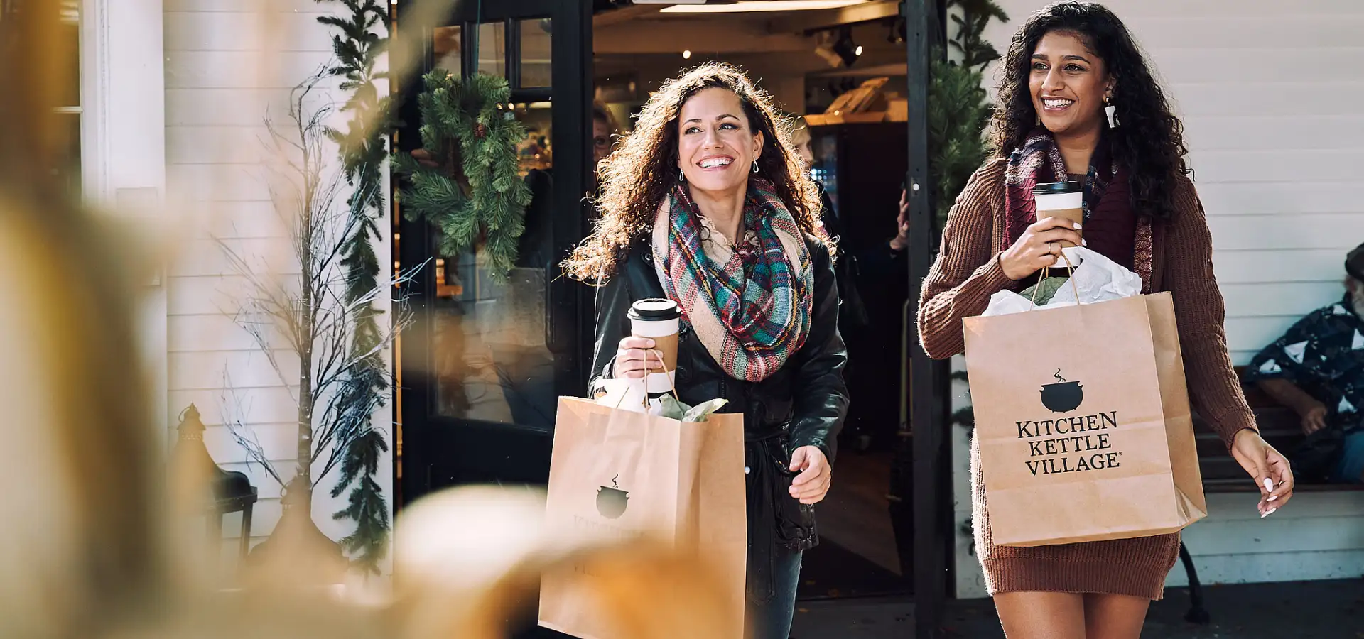 Women shopping with Kitchen Kettle Village bags in Intercourse Lancaster County PA