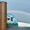 Rainbow over Kreider Farms dairy barn with silo in Lancaster County PA