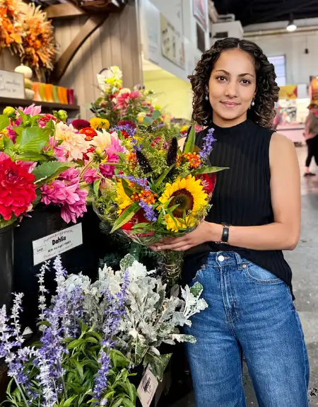 Woman holding fresh cut flower bouquet at Lancaster Central Market farmers market in Lancaster City PA