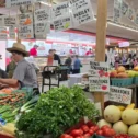 Fresh produce vendors at an indoor farmers market in Lancaster County PA