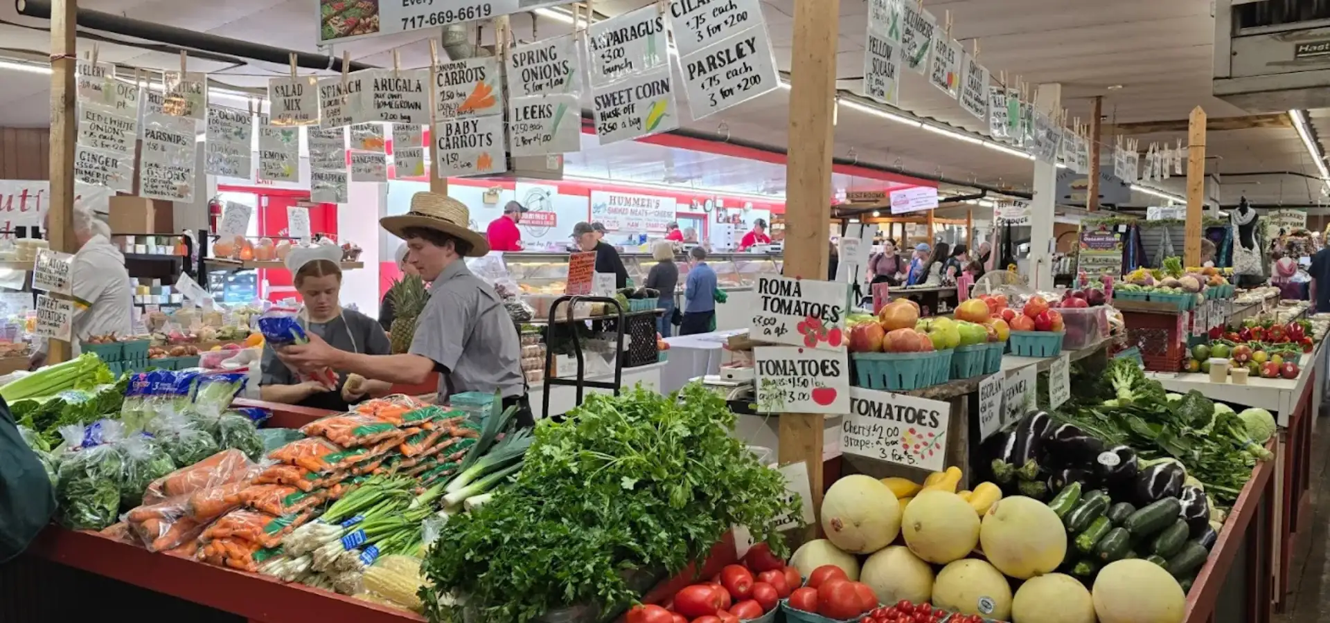 Fresh produce vendors at an indoor farmers market in Lancaster County PA