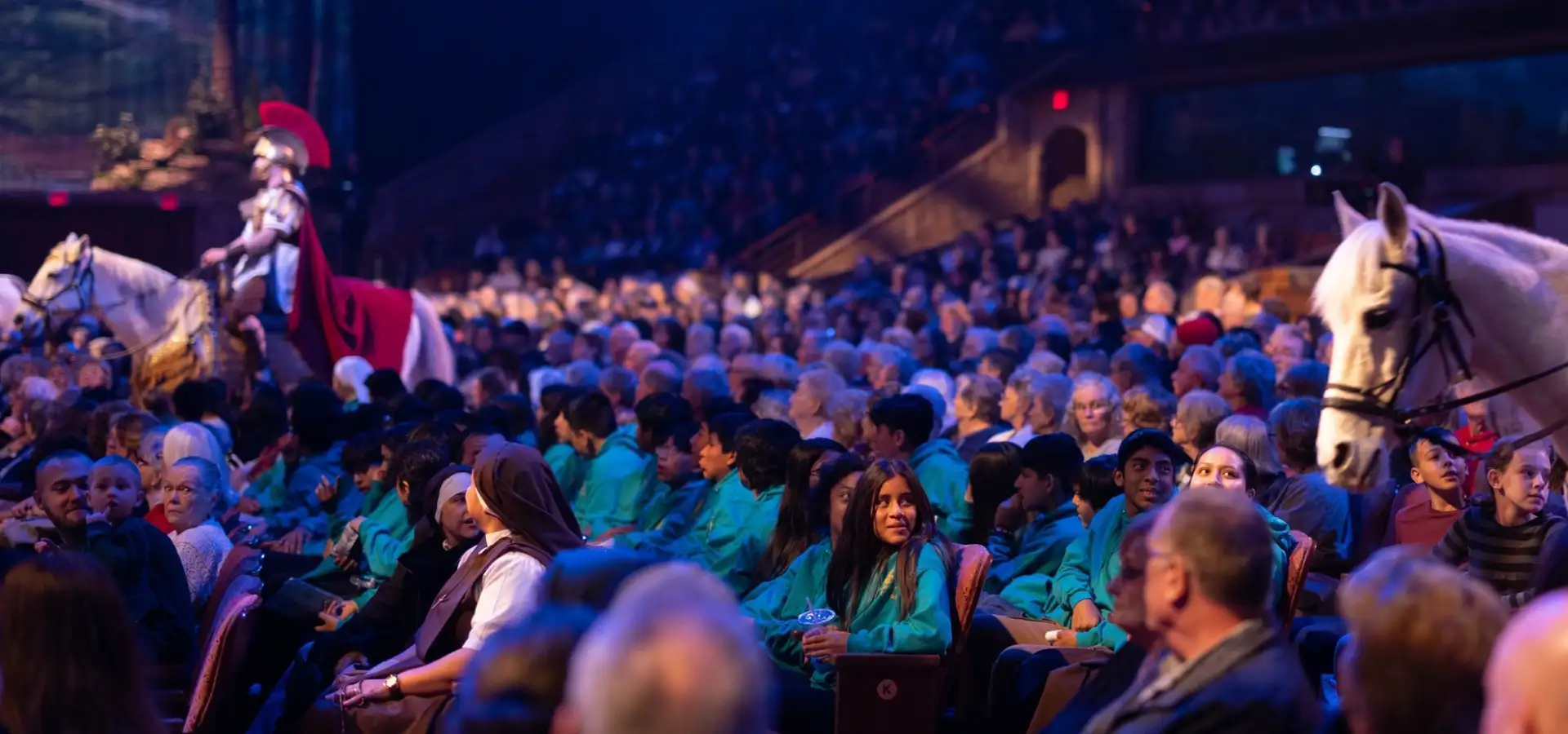 Group audience watching live biblical stage show with horses at Sight and Sound Theatre in Lancaster PA