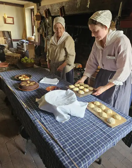 Colonial era costumed interpreters baking bread at Landis Valley Village and Farm Museum in Lancaster PA