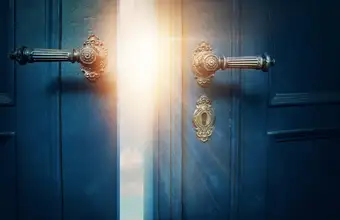 Mysterious glowing door with ornate brass handles for an escape room in Lancaster PA